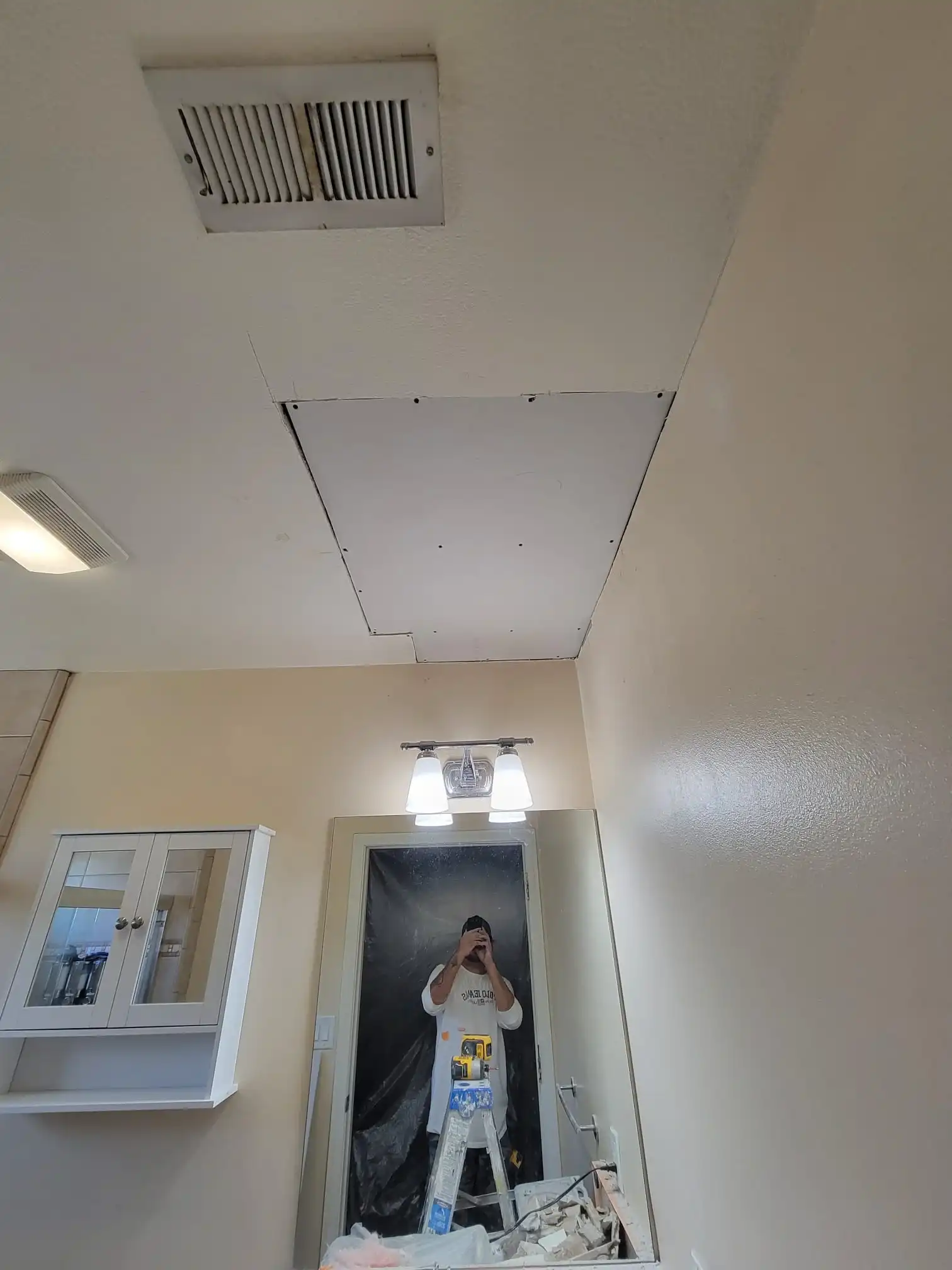 Bathroom ceiling drywall repair during home renovation in Brooklyn NY