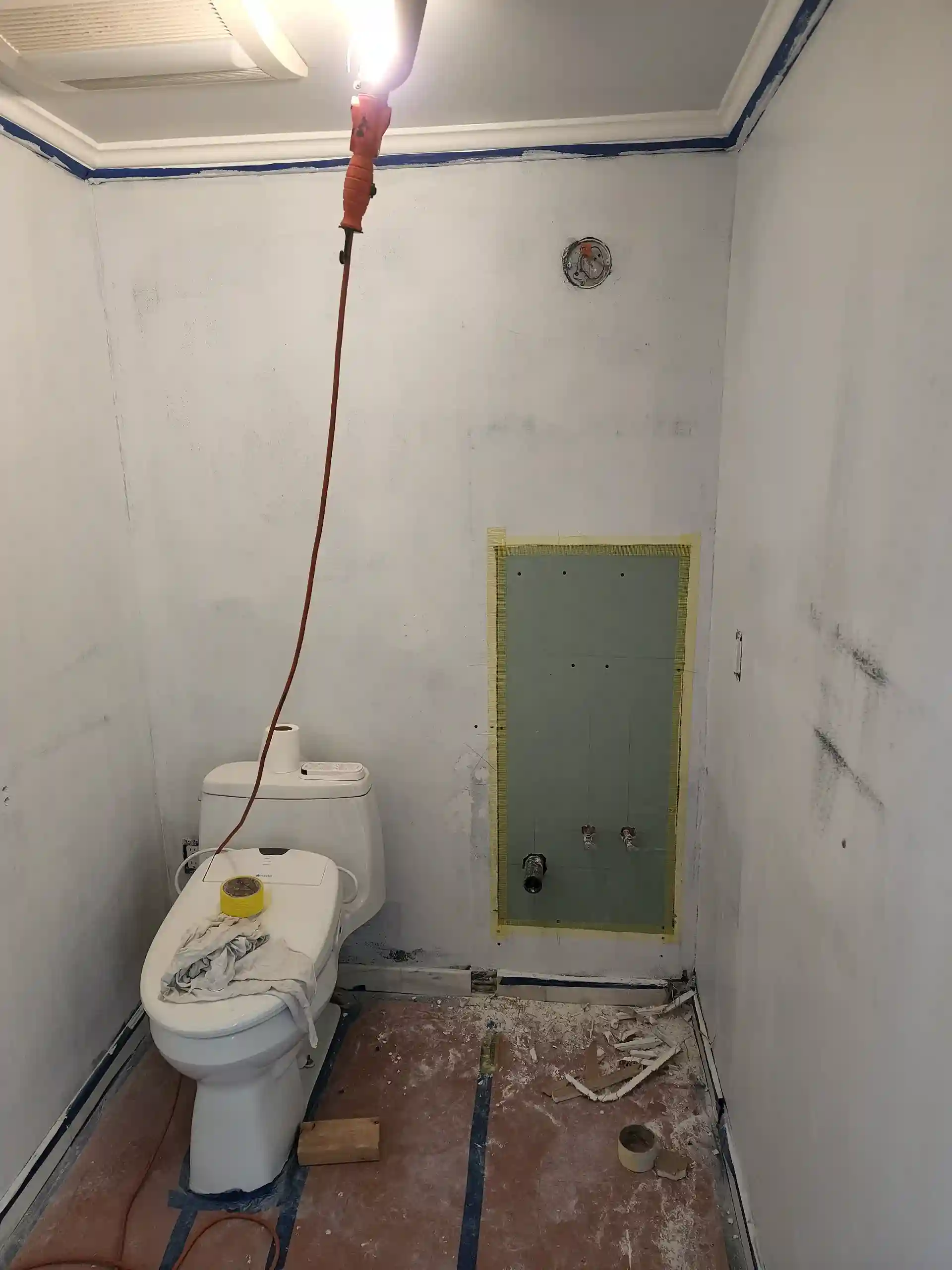 Bathroom renovation in progress with toilet and shower plumbing rough-in in Brooklyn NY