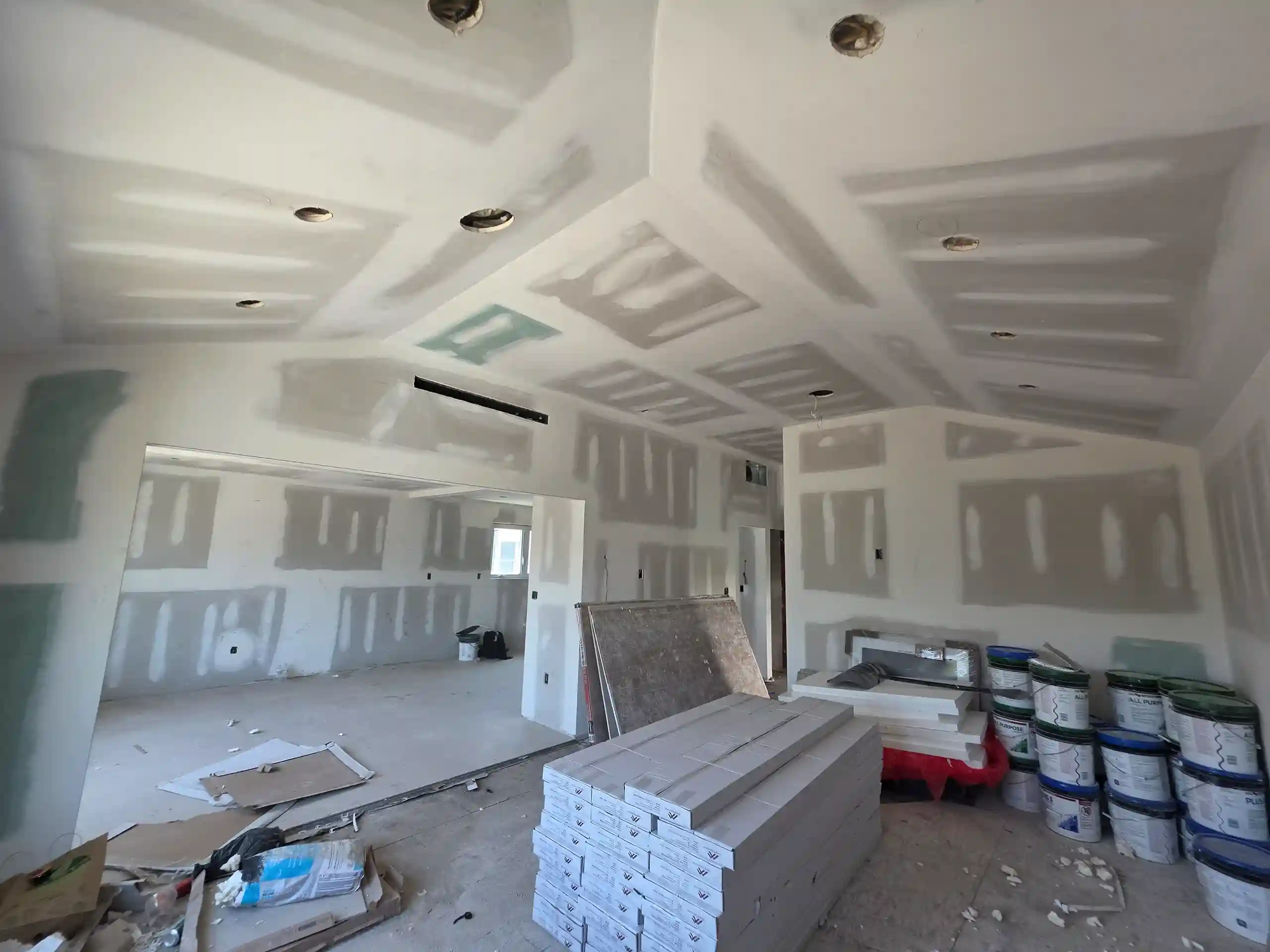 Drywall installation and finishing on walls and coffered ceiling during Brooklyn home renovation