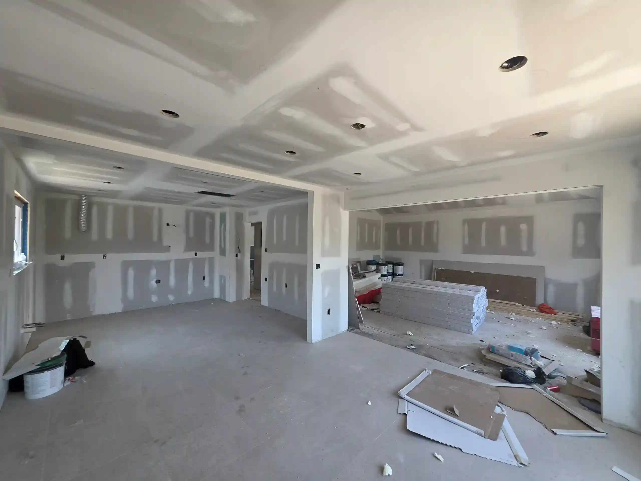 Interior home renovation in progress with drywall and recessed lighting in Brooklyn NY