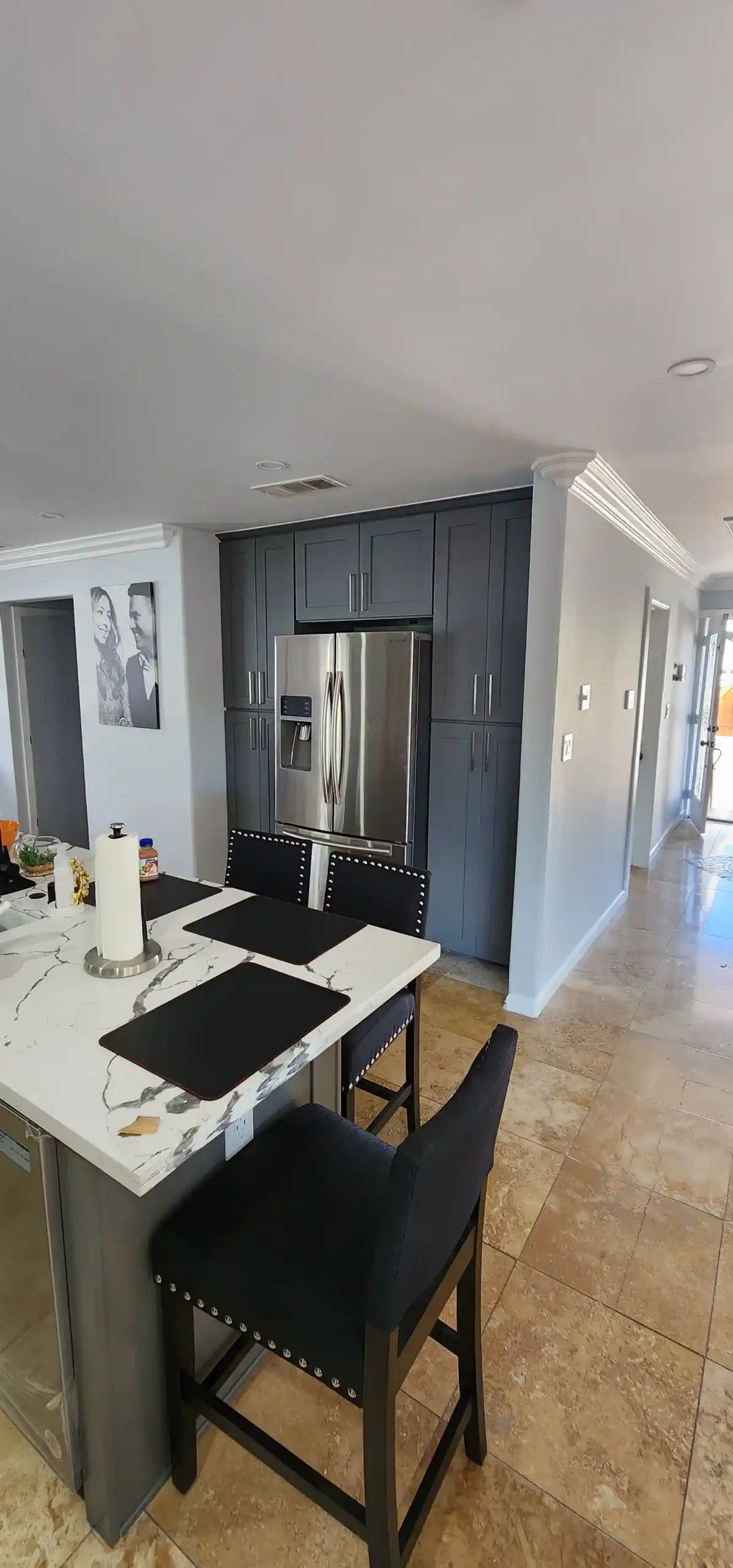 Modern kitchen renovation with white marble island, black bar stools and grey cabinetry in Brooklyn NY home